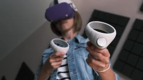 Person Using Virtual Reality Headset and Controllers
