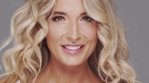 Studio Portrait of Young and Beautiful Blond Woman Over Grey Background Skin Care and Wellness