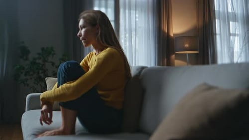 Depressed Woman Thinking Problems at Evening Home Frustrated Girl Sitting Sofa