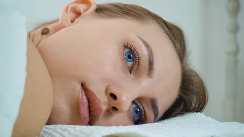 Blue Eyed Young Woman Wearing White Towel Lying Before Skin Care Spa Procedures