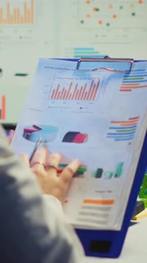 Vertical Video Close Up of Business Woman Holding Clipboard with Graphics