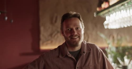 Positive Bearded Male Business Owner Standing in Bar
