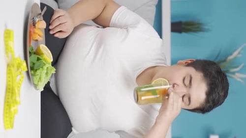 Vertical Video of Obesity boy feeling happy and peaceful on his diet.