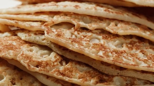 Pancakes with Condensed Milk on a Plate in a Restaurant Cutlery Knife and Fork Cut Delicious