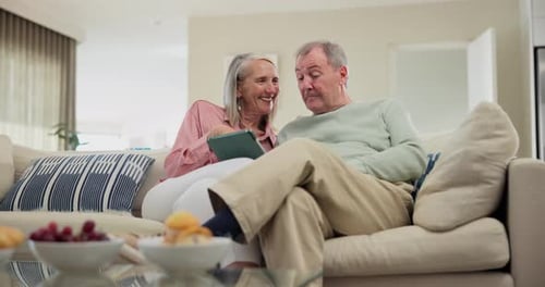 Senior Couple Relaxing at Home with Tablet