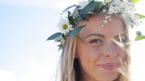 Woman in Flower Crown Smiling Outdoors in Sunlight
