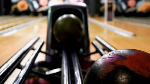 Bowling Ball Rolling Down the Lane Towards Other Balls
