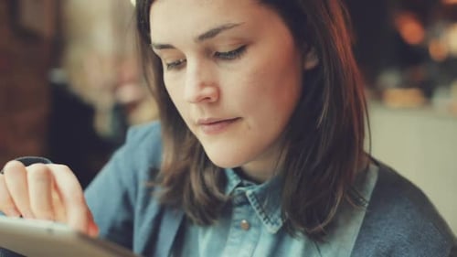 4k video footage of a businesswoman working in a cafe while using a digital tablet