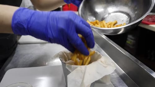 Chef Preparing French Fries in Commercial Kitchen