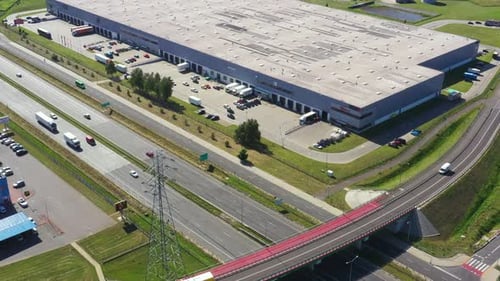 Aerial top view of the large logistics park with warehouse, loading hub with many semi-trailers truc