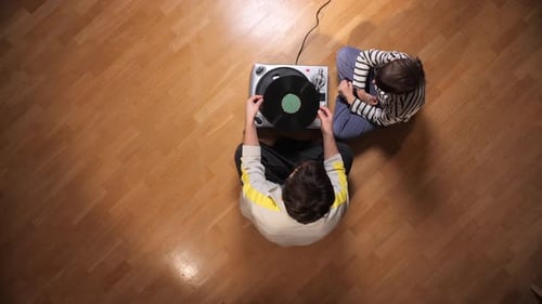 Overhead Shot: Man and Boy Listening to Vinyl Record