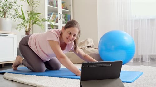 Woman Working Out at Home with Tablet