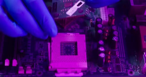 Close-up of installing computer processor, assembling motherboard.