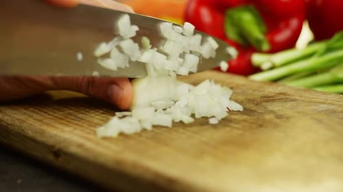 Closeup Macro Video of Male Hands Cutting Onions on a Cutting Board