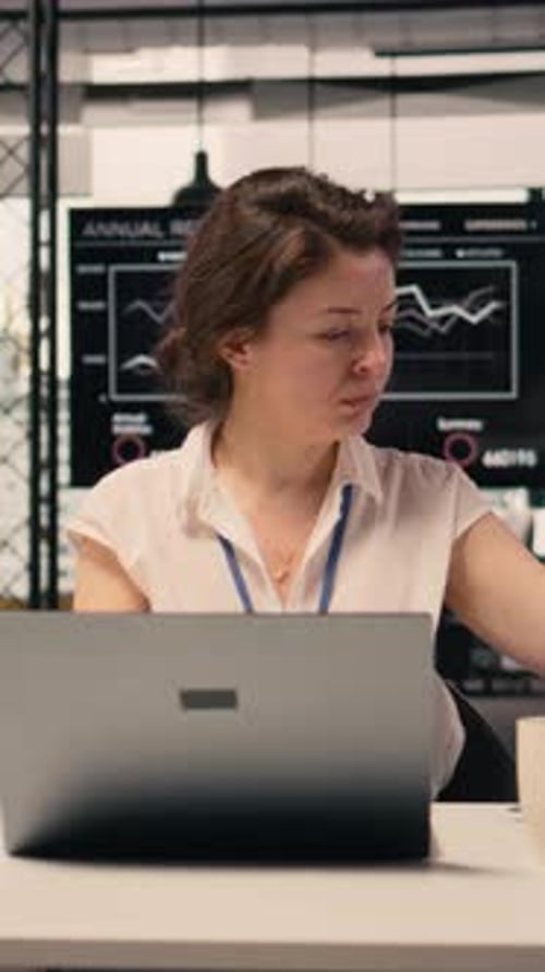 Vertical Video Businesswoman Working Alone at Office Desk Using Laptop