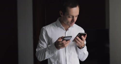 Two Mobile Phones in the Male Hands