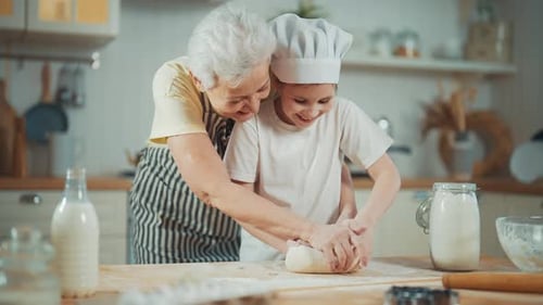 Grandmother and Child Kneading Dough in Kitchen