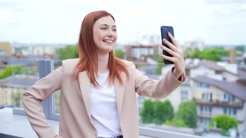 Smiling Woman Video Calling on Urban Rooftop