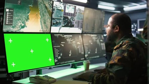 Military Agent Working in Control Room Using Software on Tablet