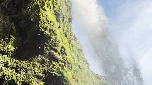 Low View of Great Waterfall Crashing Into Rocks in Iceland