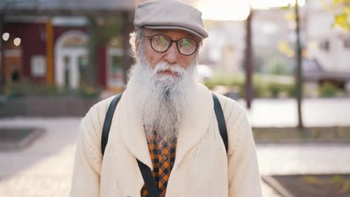 Man with Long White Beard Standing Outside
