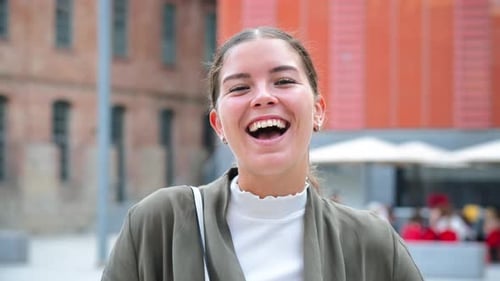 Cheerful Woman Laughing On City Plaza