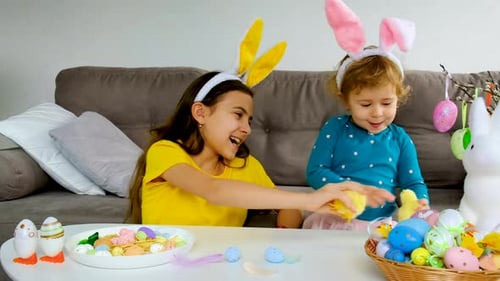 Girls with Bunny Ears Play with Easter Eggs