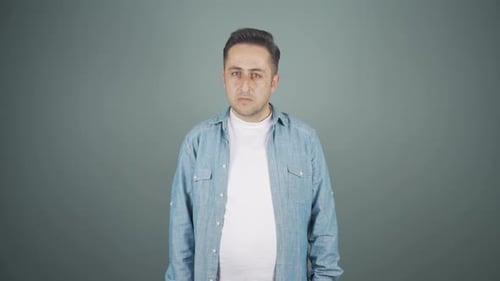 Man looking at camera with a negative expression.