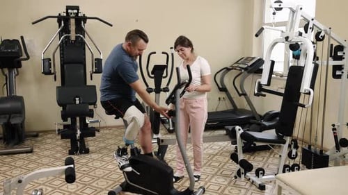 Man With Prosthetic Leg Exercising With Therapist