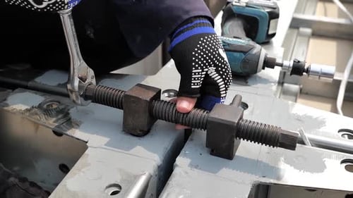 Technician Tightening Screw, Close Up