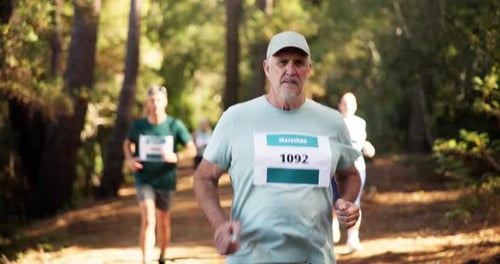 Runner, marathon and mature man in forest for exercise, fitness training and cardio workout
