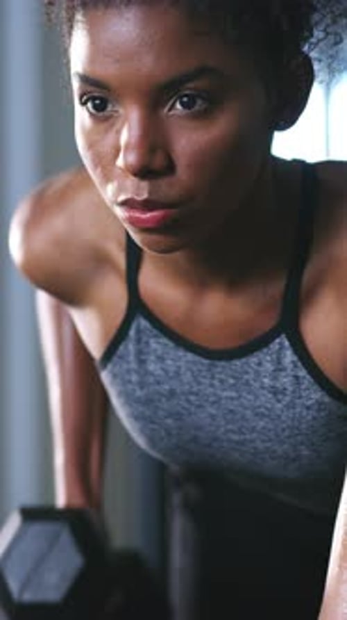Fitness, gym and black woman with weights for exercise, bodybuilder training and muscle workout