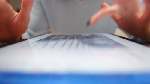 Close Up of Manicured Female Hands Browsing Images in the Internet