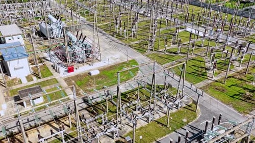 aerial view electric substation, pylon power line high voltage, electrical transmission field,