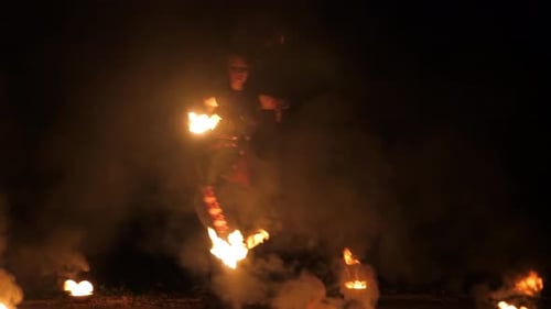 Woman Performing Fire Dance at Night