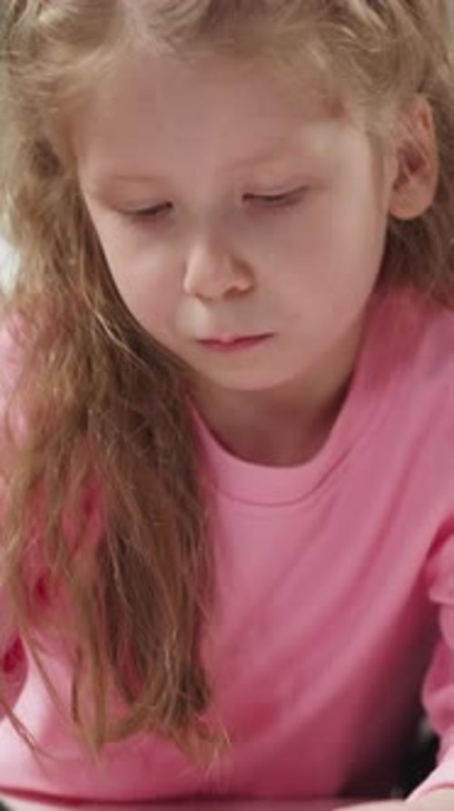 Child Drawing at Table Indoors in Close Up