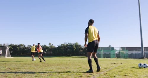 Playing soccer on field, men in sportswear training and passing ball