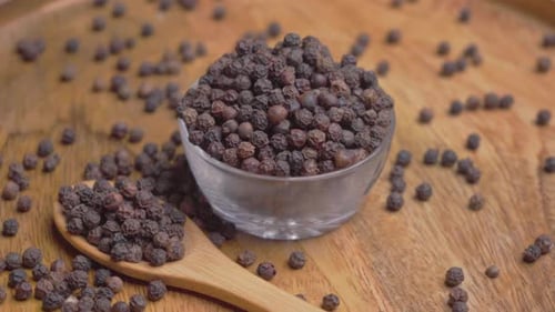 Black Peppercorns with Wooden Spoon in Kitchen