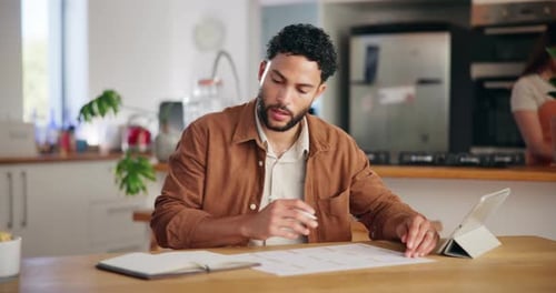 Young Adult Man Working at Kitchen Table