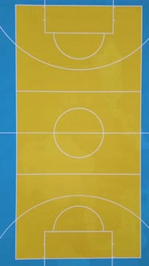 Aerial View of a Colorful Outdoor Basketball Court with Vibrant Blue and Yellow Markings Two Hoops