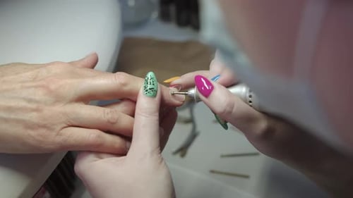Manicurist Giving Client Manicure in Nail Salon