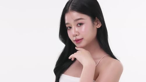 Close up portrait beautiful young Asian woman with healthy facial glass skin over white background.