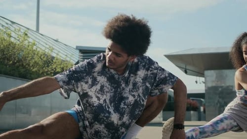 Athletic Couple Stretching Together Outdoors before Street Workout