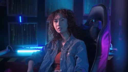 an asian woman programmer is working in her computer room