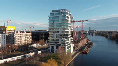 Berlin wall from the river Spree with a drone flying along the river and showing the Berlin TV anten