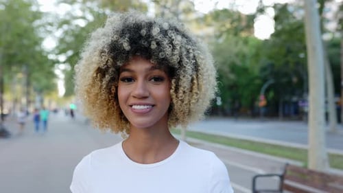 Portrait of Young Woman Smiling at Camera Standing at City Street