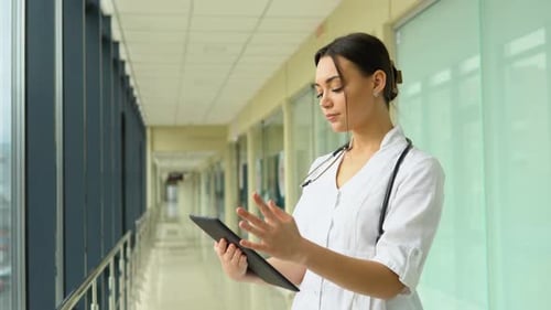 Portrait of Beautiful Young Woman Doctor Holding Digital Tablet and Looking at Camera Confident