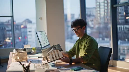 Building Company Worker Planning Architectural Design Holding Model at Office