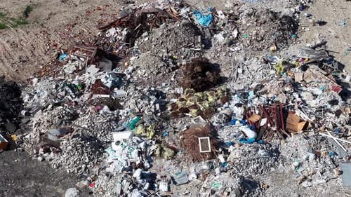 Drone aerial view over large illegal dump site