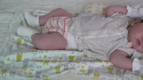 A Cute Baby Girl Sleeping Peacefully In The Crib - close up